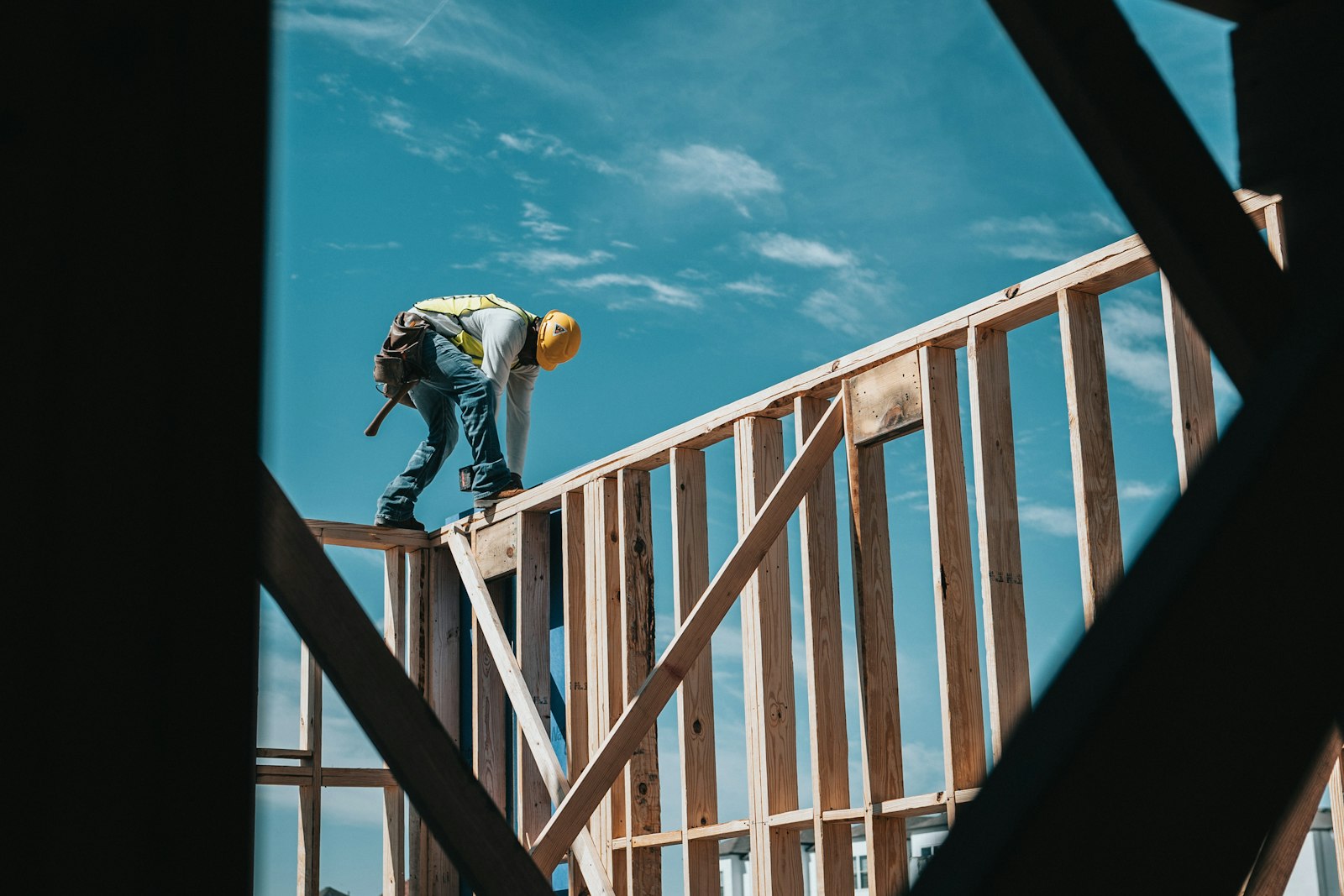 Construction worker in hard hat on building frame