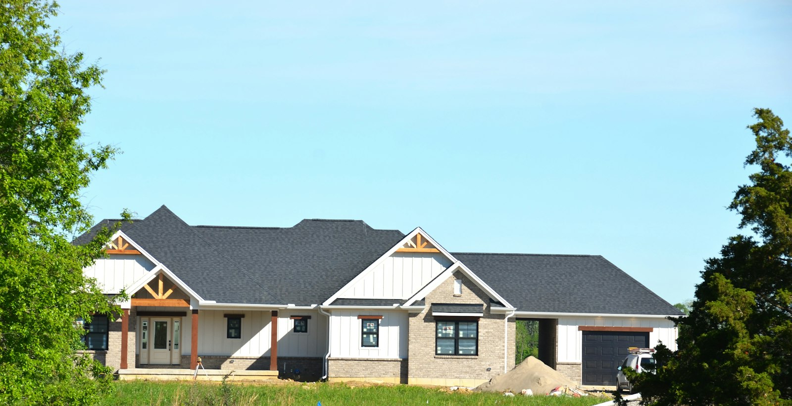 A modern house under construction with a gray roof