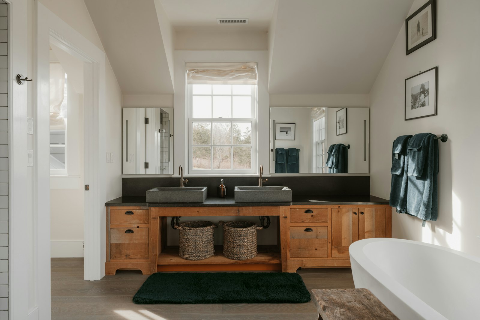 A modern bathroom with double sinks and a bathtub