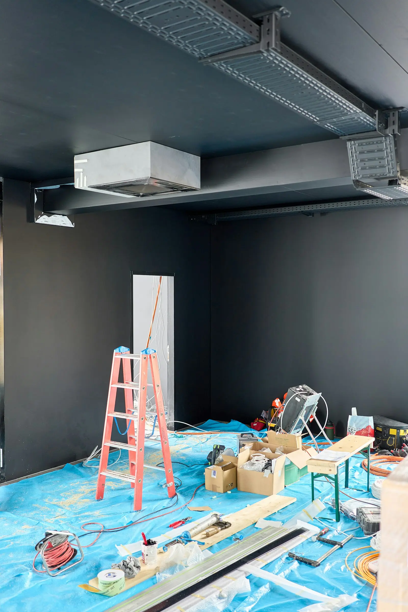 Interior construction site with tools and ladders