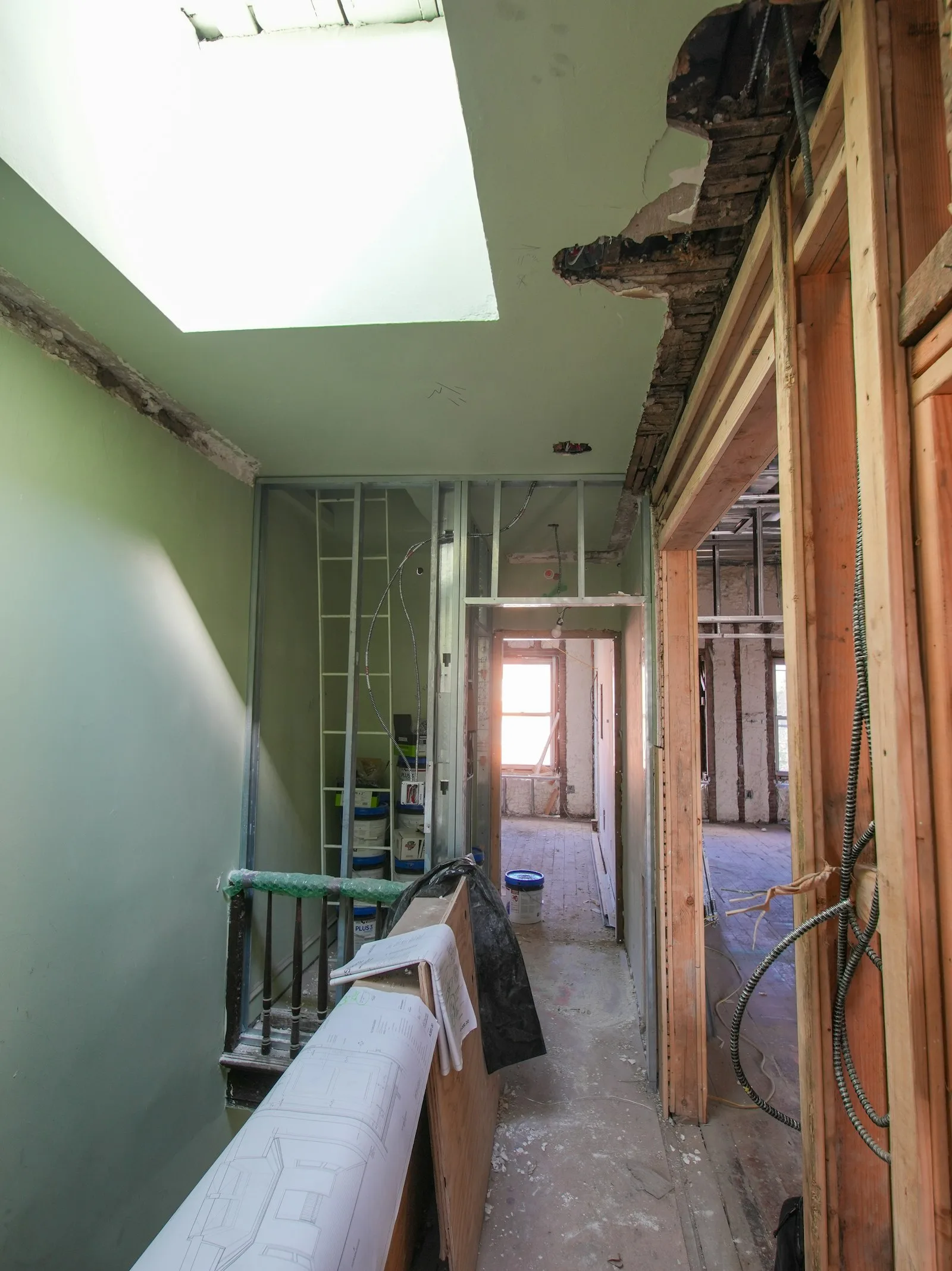 Interior hallway under renovation with exposed framing