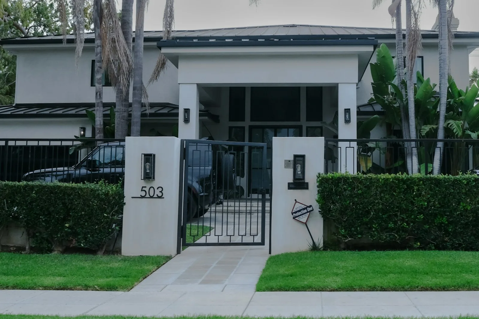 Modern house with manicured hedges and gate