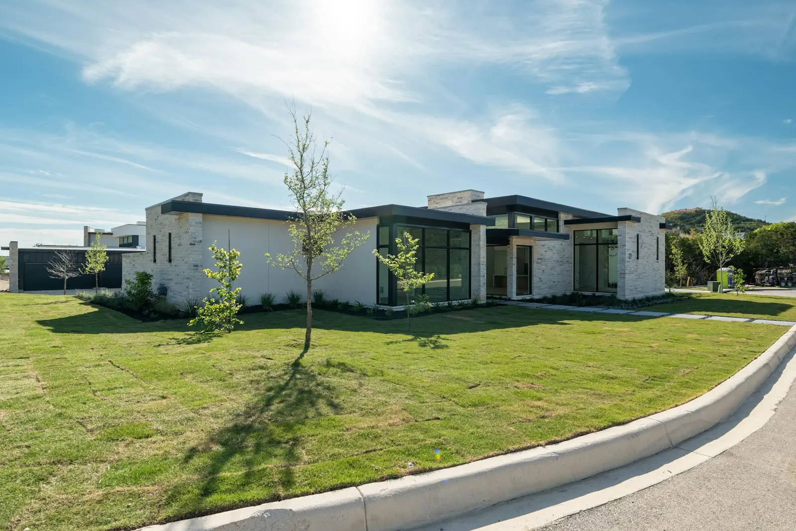 Modern house with a green lawn under a sunny sky