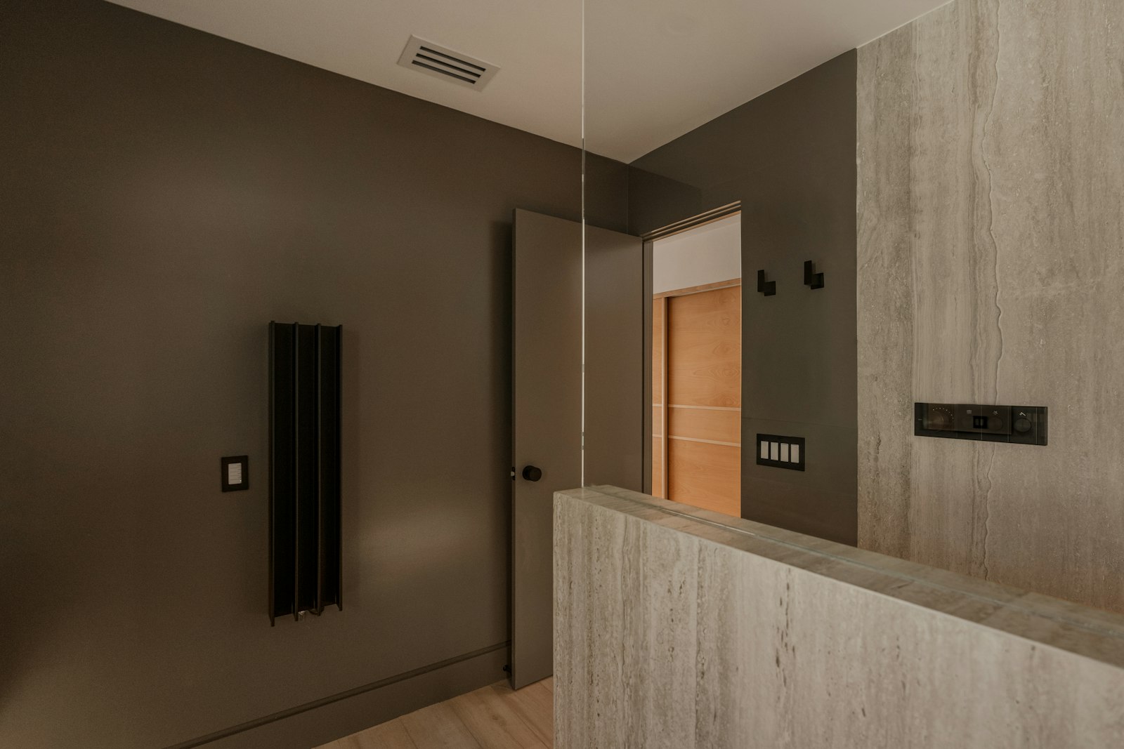 Modern bathroom with dark walls and wood accents