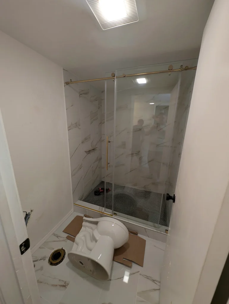 Bathroom Fixture Installation — White Tile Shower & Bathroom