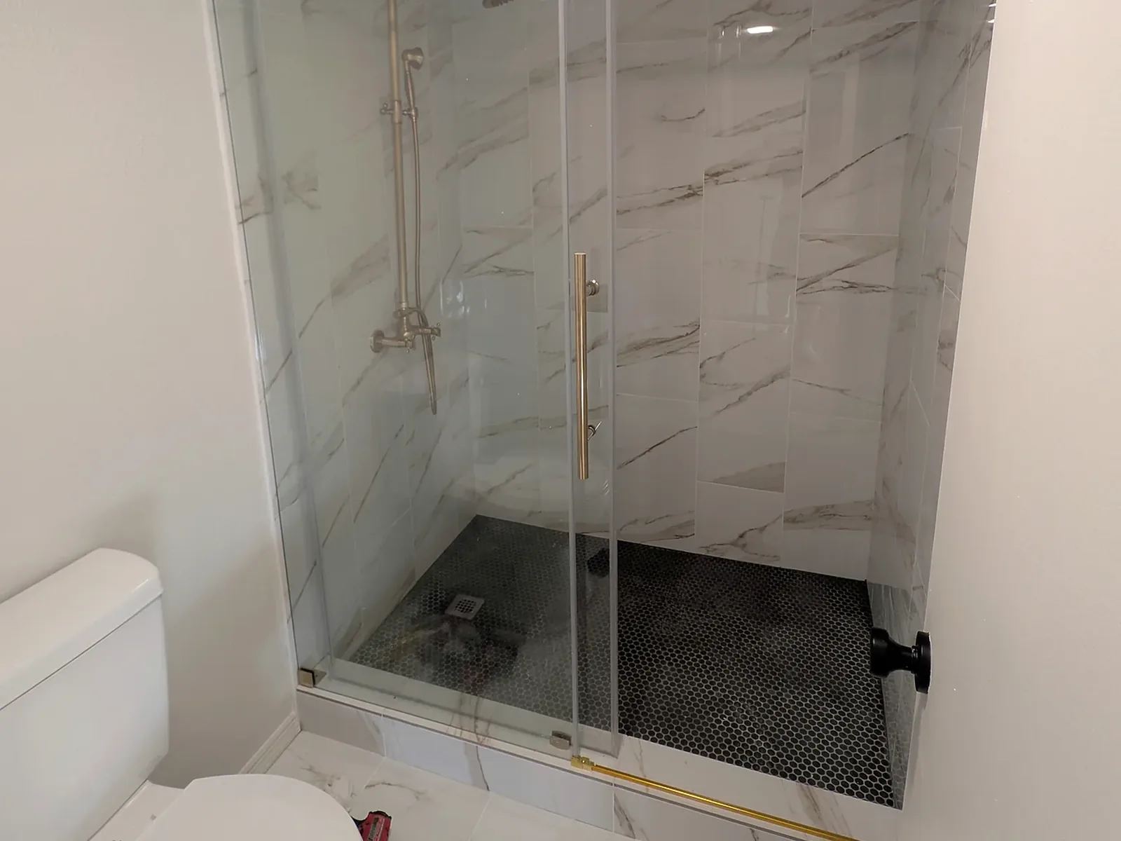 Shower Glass and Installed Fixtures — White Tile Shower & Bathroom